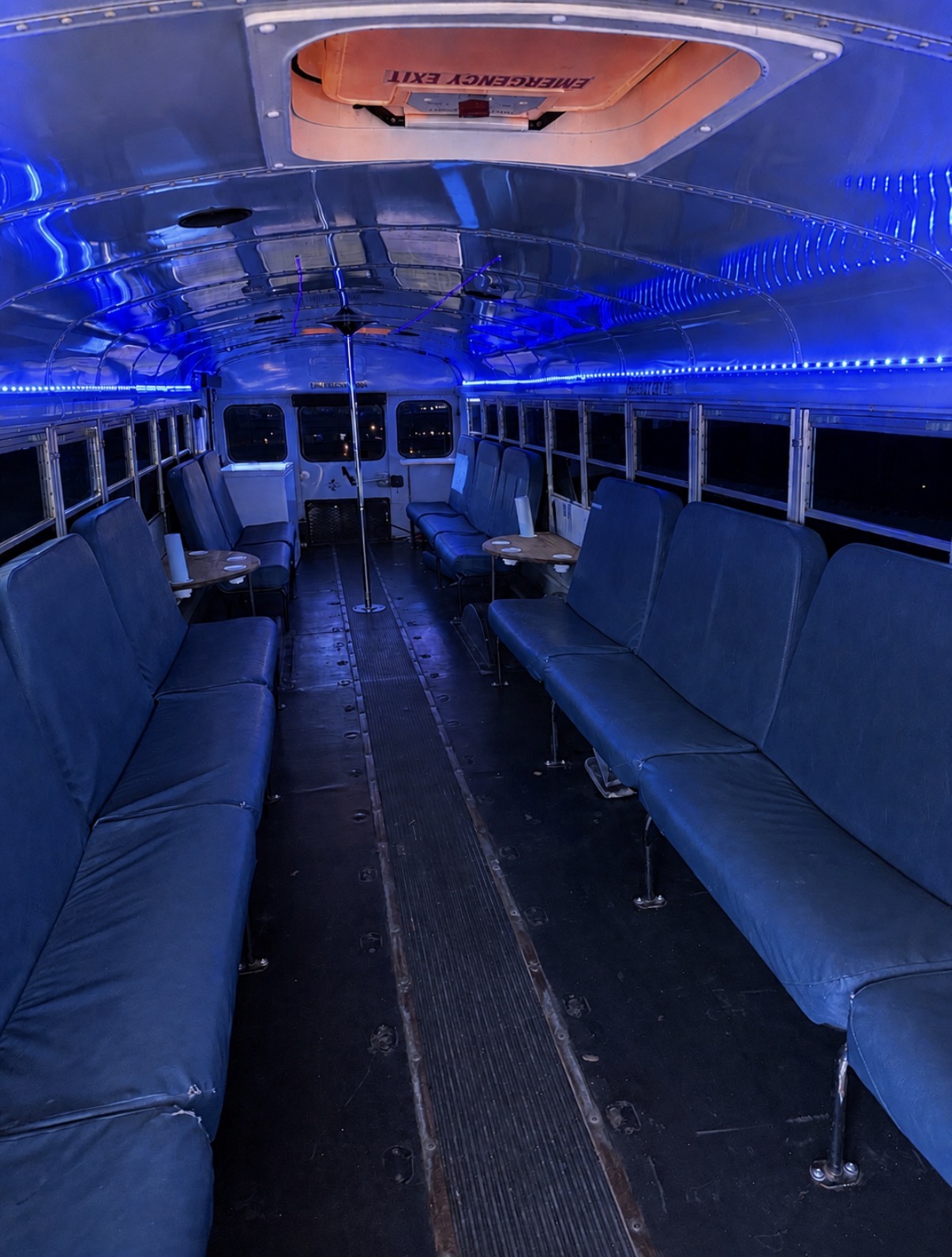 Bus interior with blue LED lighting and lounge seating
